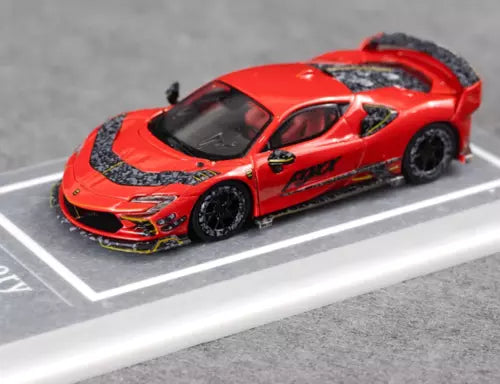 Red diecast racing sports car model with black graphics, hood vents, and front splitter