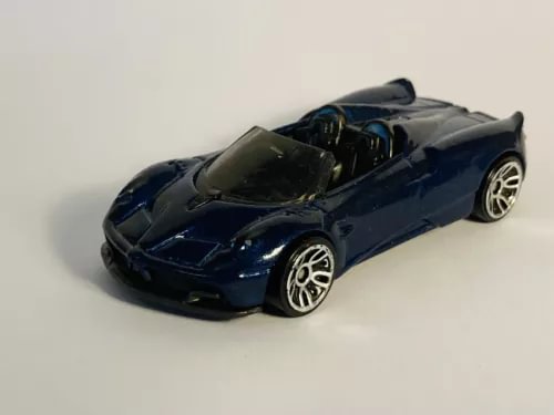 Hot Wheels diecast roadster car, dark blue with silver wheels
