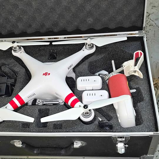 DJI Phantom 2 Vision+ quadcopter drone, white with red accents, in storage case
