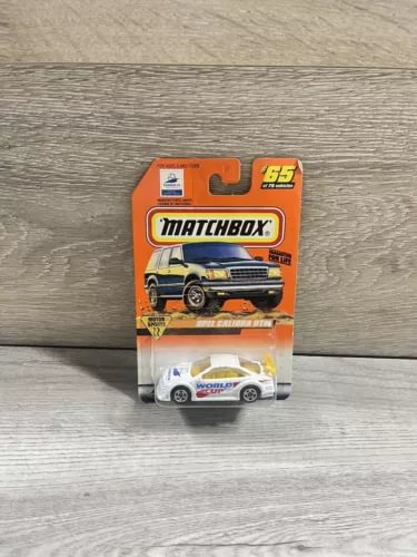 Diecast model car in Matchbox blister pack, orange and white racing livery