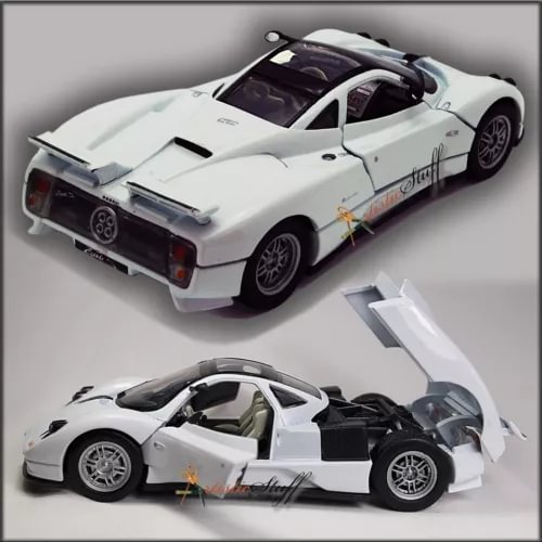White 1:24 scale diecast sports car model with open doors and black interior