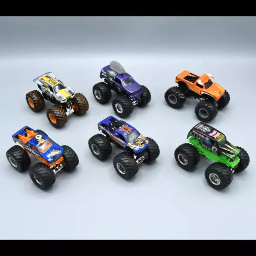Six diecast monster trucks, including orange, purple, blue, black, and green vehicles