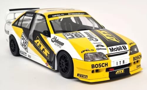 Diecast race car model, yellow/white/black with sponsor decals, front 3/4 view.
