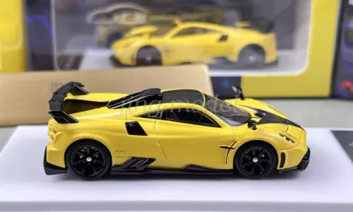 Yellow sports diecast car model with black wheels and aerodynamic body kit