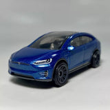 Blue diecast model car, front three-quarter view with detailed grille and headlights