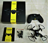 Quadcopter drone kit with black controller, user guide, and spare propellers