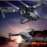 Foldable gray quadcopter drone with front camera and obstacle sensor lights