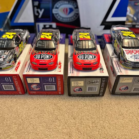 Red diecast race car model with yellow #24 logo, on red retail box