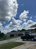 Quadcopter drone with camera, flying in the sky