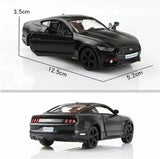 Black diecast model car toy with open driver door, side view