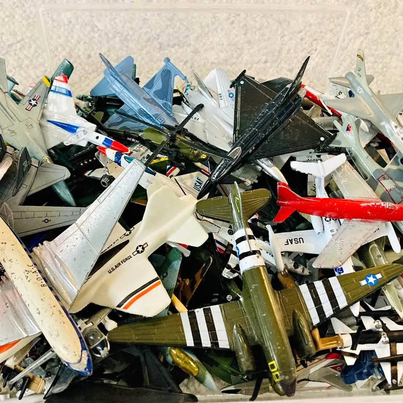Vintage diecast model aircraft assortment with multicolored planes and wings