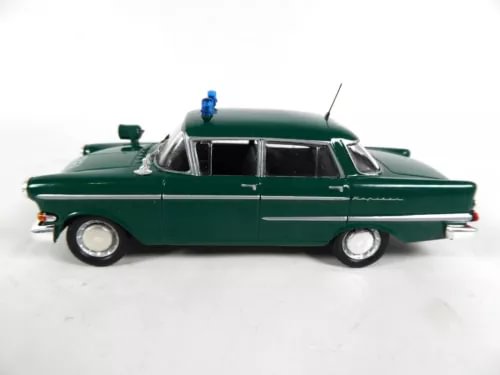 Green police diecast car model with blue roof light, 1/43 scale