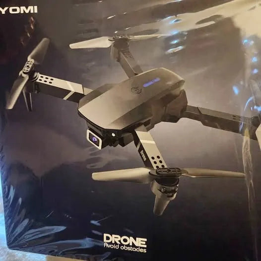 Foldable gray quadcopter drone with four propellers and front camera sensor
