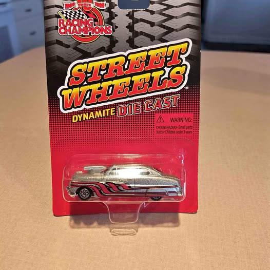 Dynamite die-cast race car toy, silver with red and black stripes, in blister pack