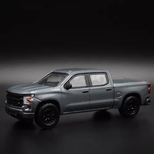 Gray Chevy Silverado 1500 diecast pickup truck model, 1:64 scale, black wheels