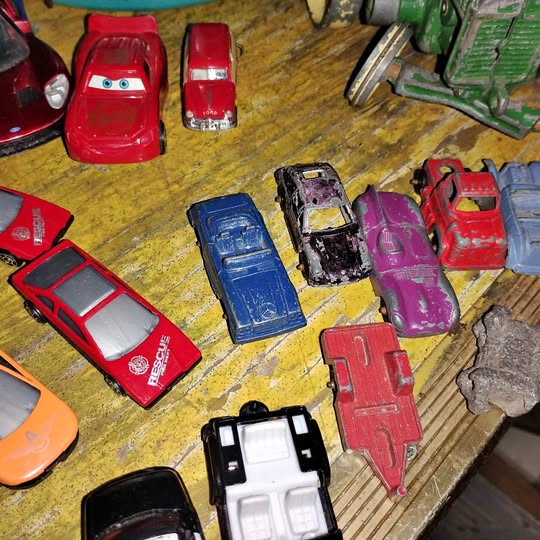 Diecast toy cars assortment in red, blue, purple, and black, in varied body styles