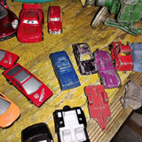 Diecast toy cars assortment in red, blue, purple, and black, in varied body styles