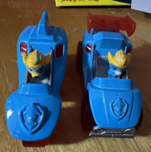 Blue diecast pup car toys with yellow-headed figures and paw emblem, twin set