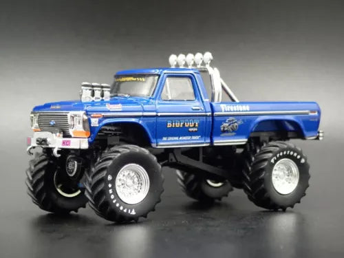 Blue monster truck diecast model with oversized tires, chrome rims, and white exhaust.
