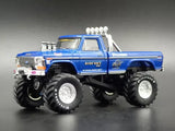 Blue monster truck diecast model with oversized tires, chrome rims, and white exhaust.