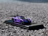 Purple diecast sports car model on black display base