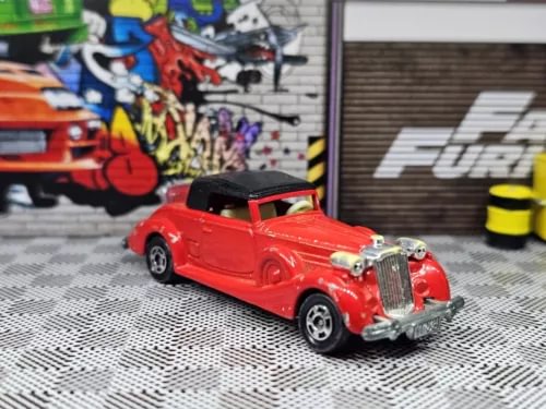 Red vintage diecast car with chrome grille and black roof detail