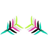 3-blade FPV drone propellers: neon green hubs with teal, pink, and black blades