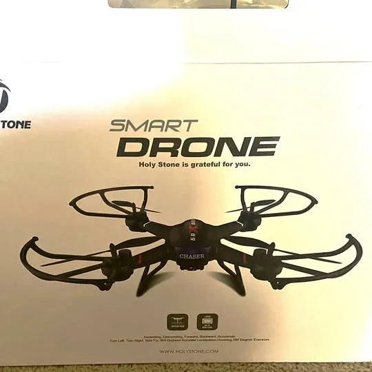 Black quadcopter drone with four foldable propellers on display packaging
