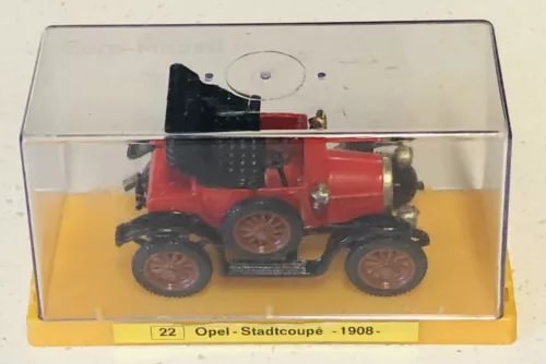 Red diecast Opel Stadtcoupe 1908 model car in clear display case