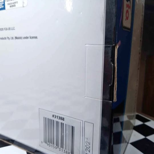 1/18 scale diecast car in retail box, barcode label visible on side
