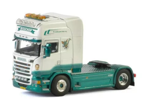 Diecast model truck with white cab and green chassis, detailed grille and cab interior