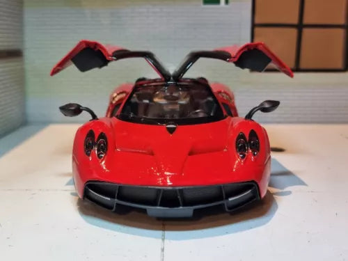 Red diecast supercar model car with open scissor doors, front view, detailed front grille