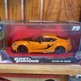 Yellow diecast Toyota GR Supra model car in clear box