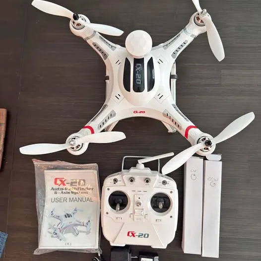 RC camera drone with white quadcopter, controller, batteries and user manual