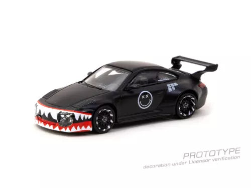Matte black 1/64 diecast sports car with rear wing and red shark-mouth grille