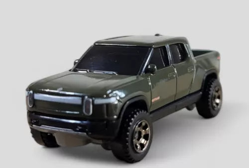 Green die-cast model pickup truck, front 3/4 view, detailed grille and headlights