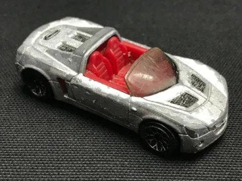 Silver diecast model car with red interior, front three-quarter view.