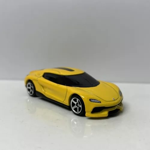 Yellow diecast sports car model, 1:64 scale with black windshield