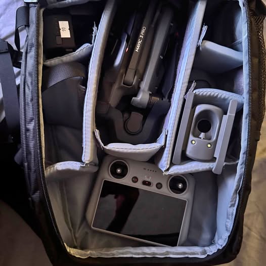 Folding drone in open protective case with controller and accessories