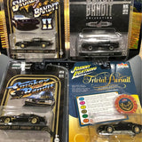 Green diecast Trans Am model car in retail blister pack, Greenlight and Johnny Lightning.