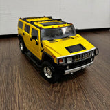 Yellow Hummer H2 diecast SUV model with black grille and hood details