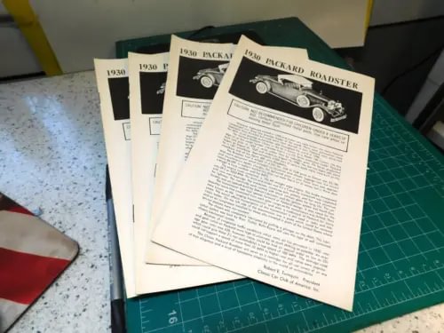 1930 Packard Roadster diecast car brochure, printed paper pages stack
