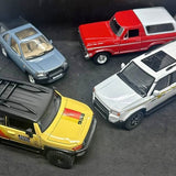 1:24 diecast collection of multiple cars: yellow, white, red, and blue pickups.