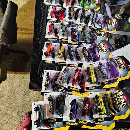 Diecast toy car blister pack assortment in various colors, displayed on cards