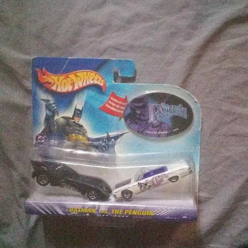 Hot Wheels blister pack with Batman and Penguin diecast cars, clear plastic cover