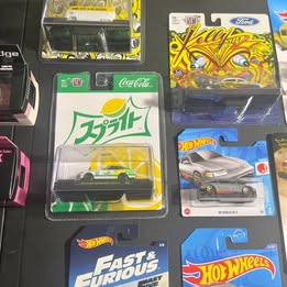 Hot Wheels diecast car assortment in boxed packaging, multiple vehicles visible