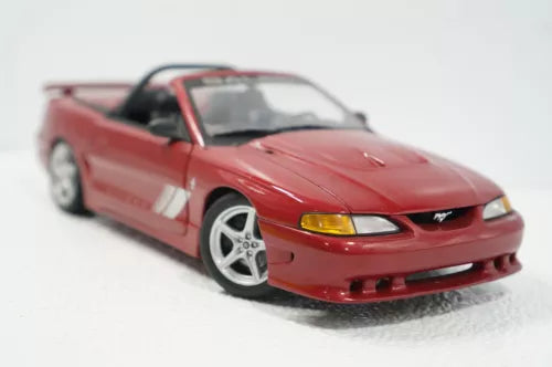 Red convertible diecast model car with front 3/4 view, detailed grille and wheels