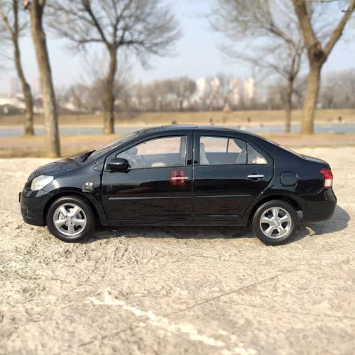Black 1:18 diecast sedan model car, side view, silver wheels
