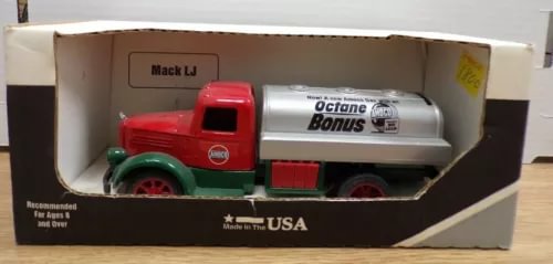 Diecast gas tanker truck with red cab and white fuel tank, in display box.