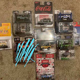 Collectible diecast toy cars in blister packaging, several boxed vehicles